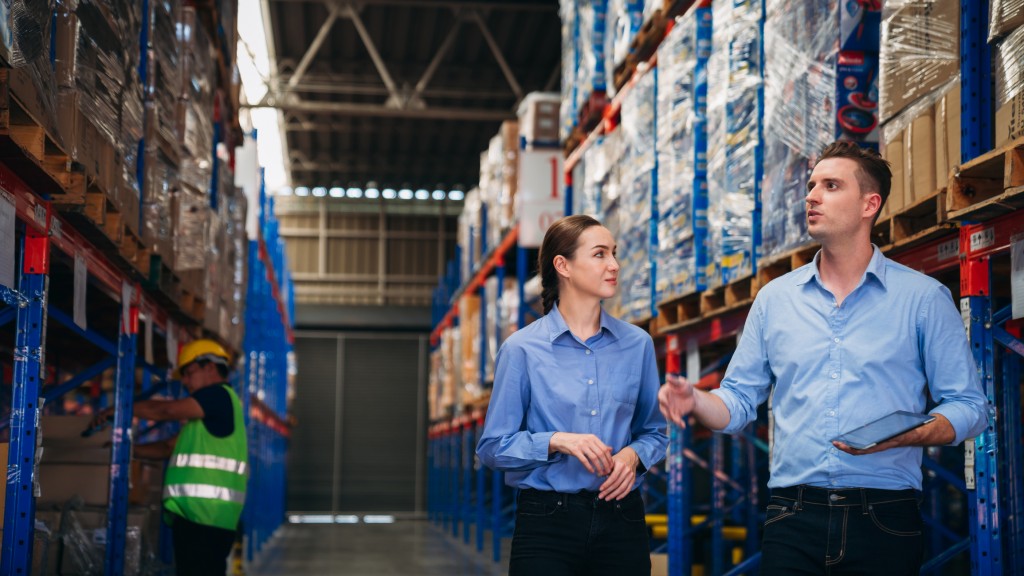 Warehouse worker working and checking the stock in the warehouse.  Factory manager using digital tablet check barcode in industry factory logistic.